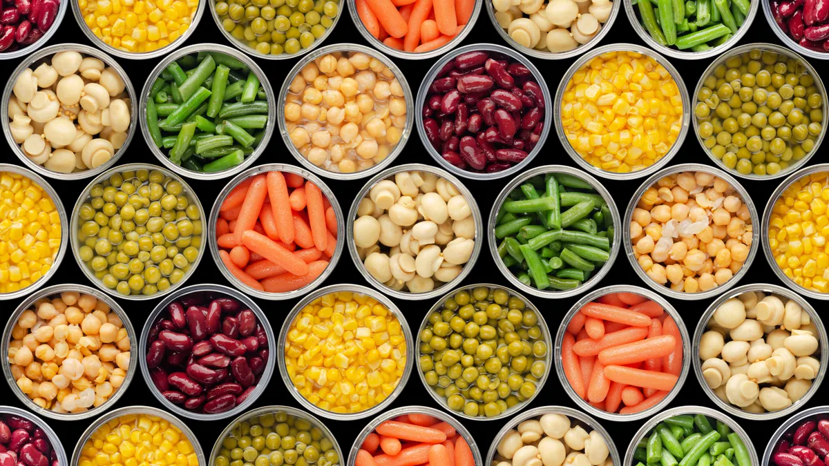 A birdseye view of a bunch of open cans with canned food inside.