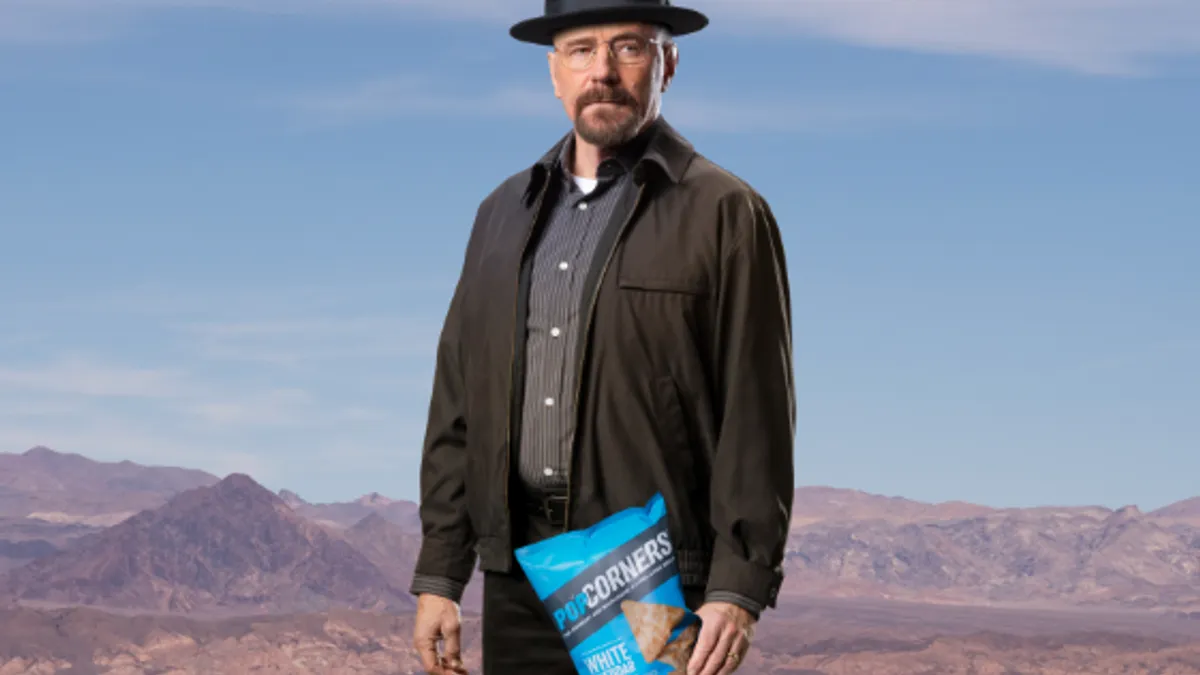 "Breaking Bad" star Bryan Cranston poses with a bag of PopCorners for the brand's Super Bowl LVII ad teaser.