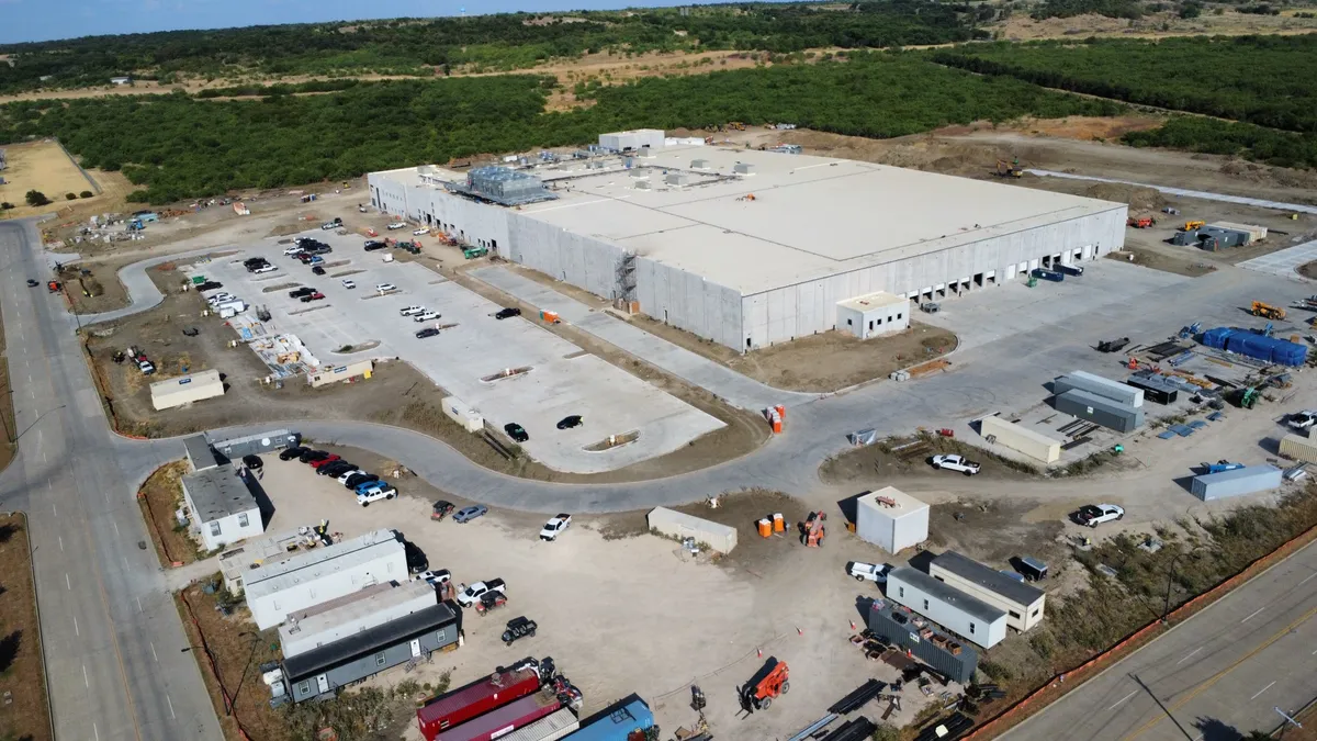 An aerial view of SunOpta's Midlothian, Texas factory, surrounded by construction trailers, roads and woods.